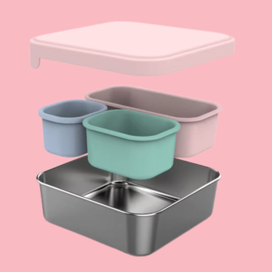 stainless steel square container or sandwich box with pink lid on a pink showing internal 3 silicone cups 