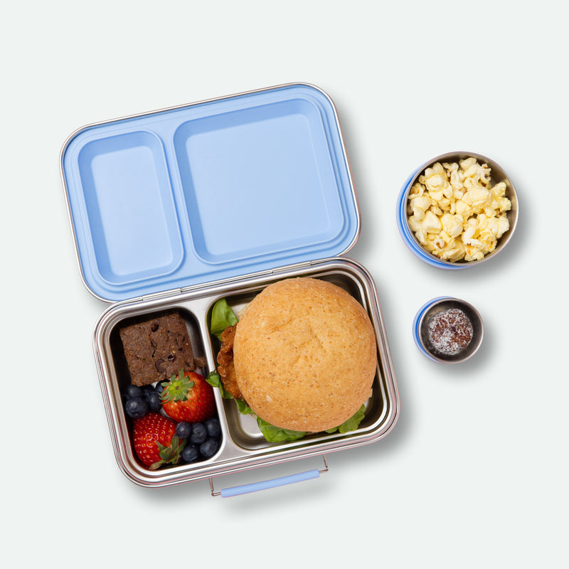 two compartment leak proof stainless steel lunch box with removable silicone seal in light blue full of food