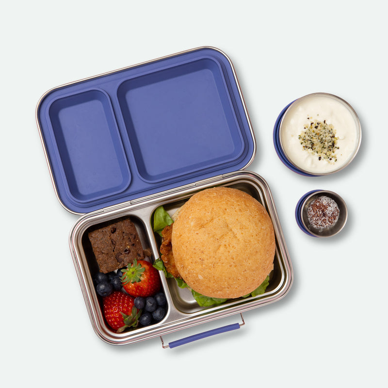 two compartment leak proof stainless steel lunch box with removable silicone seal in indigo full of food