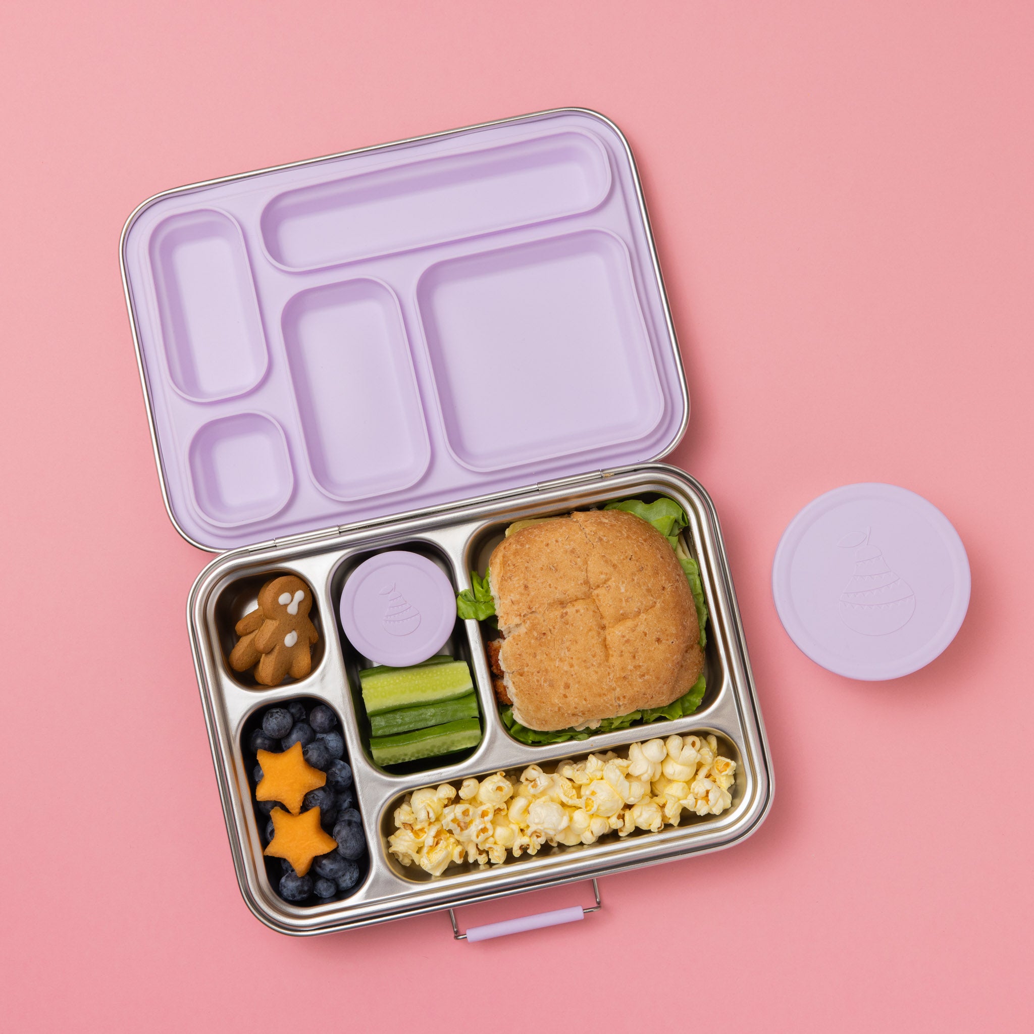 five compartment stainless steel lunch box with soft lilac seal and lids full of food