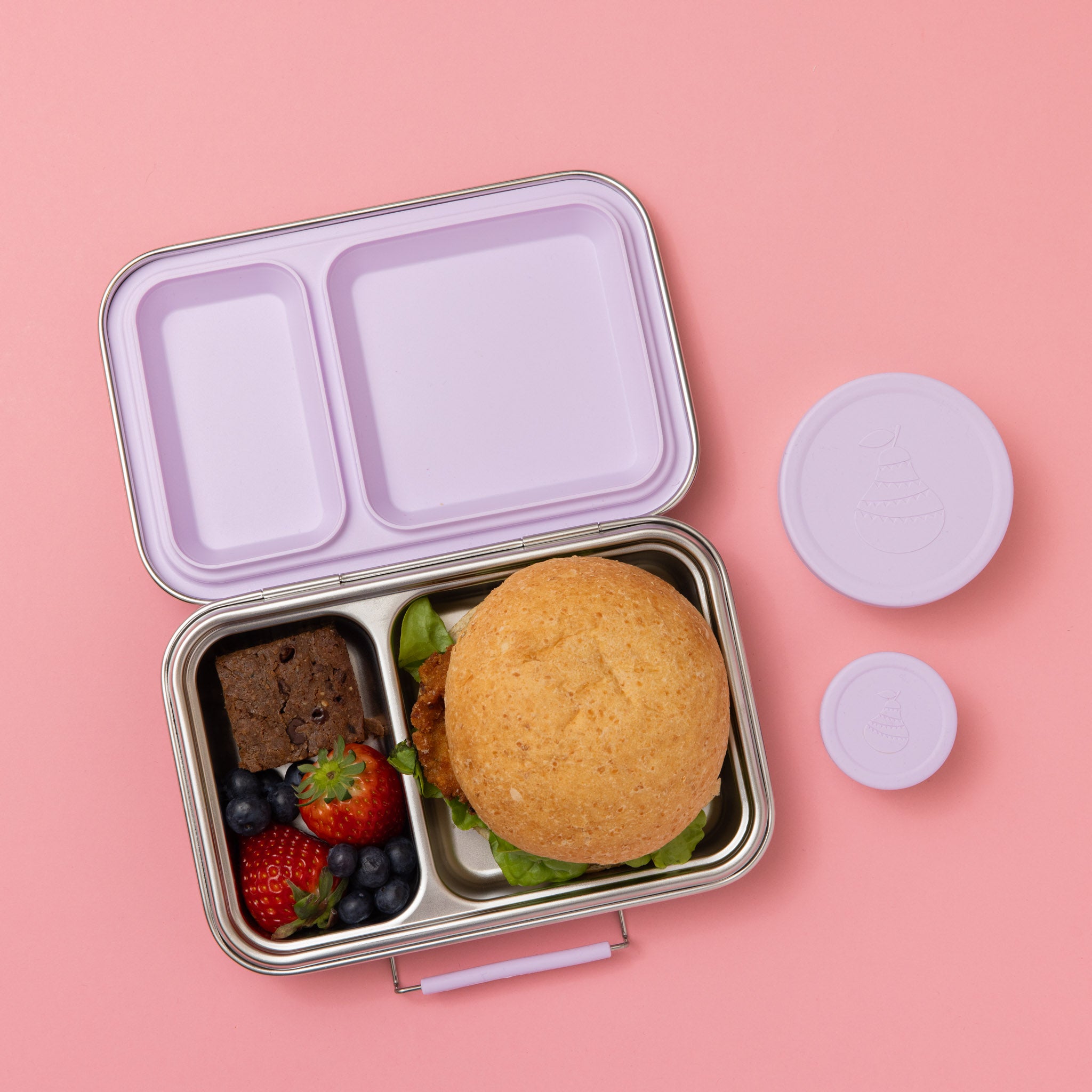 stainless steel two compartment lunch box with soft lilac/purple seals and clasp, full of food