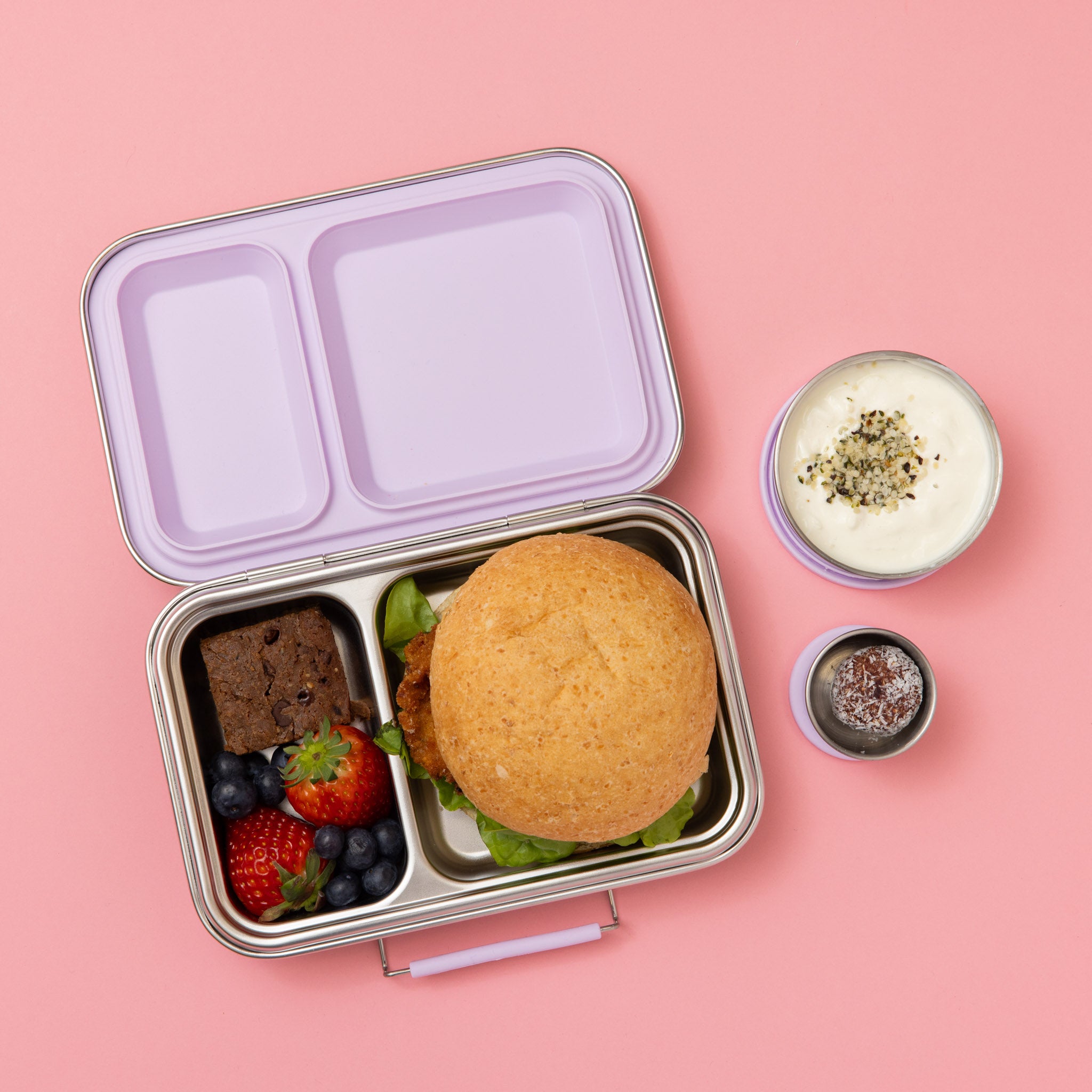 stainless steel two compartment lunch box with soft lilac/purple seals and clasp empty with two snack pots with pear logo on side with food in them