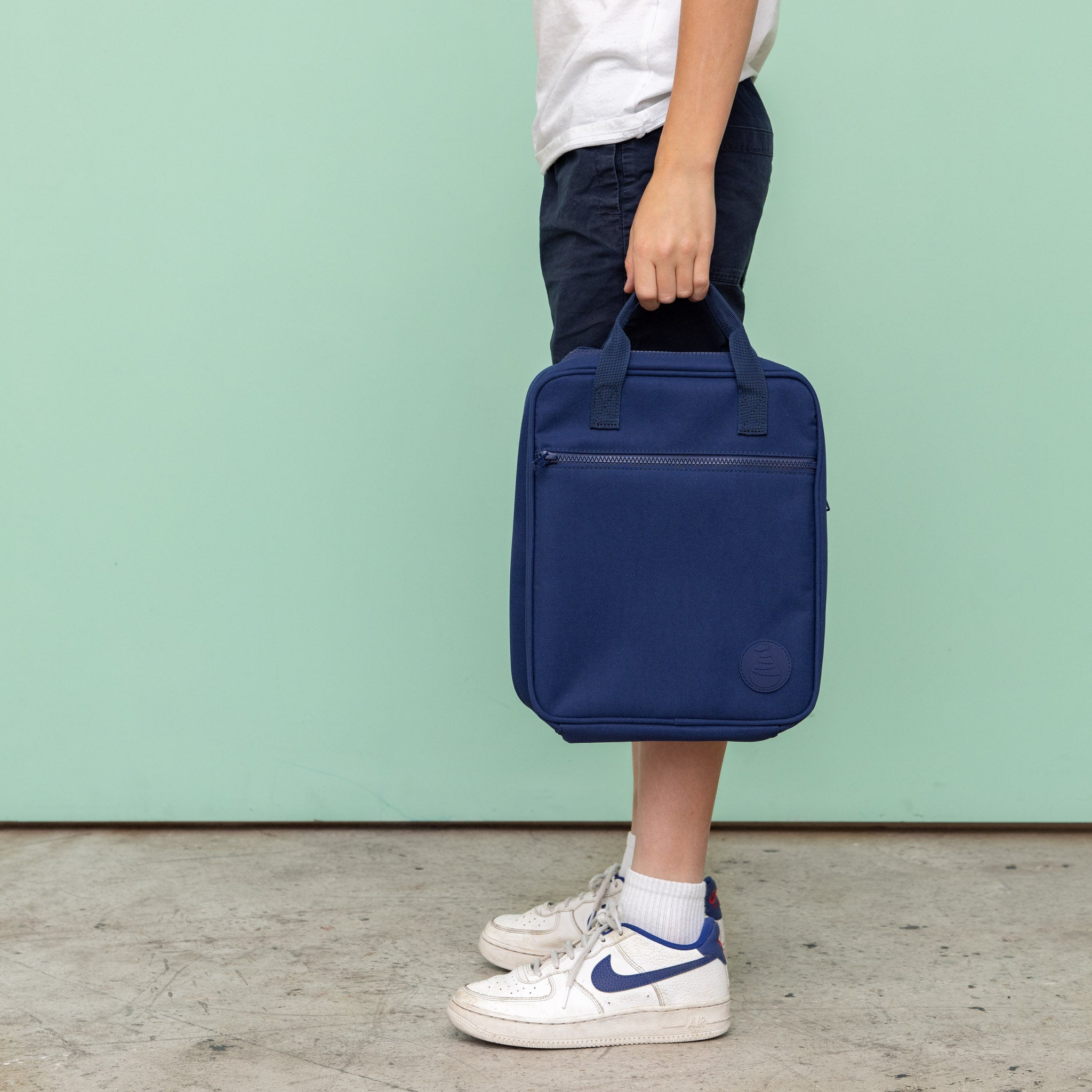 Navy Jumbo lunch bag being held by boy 