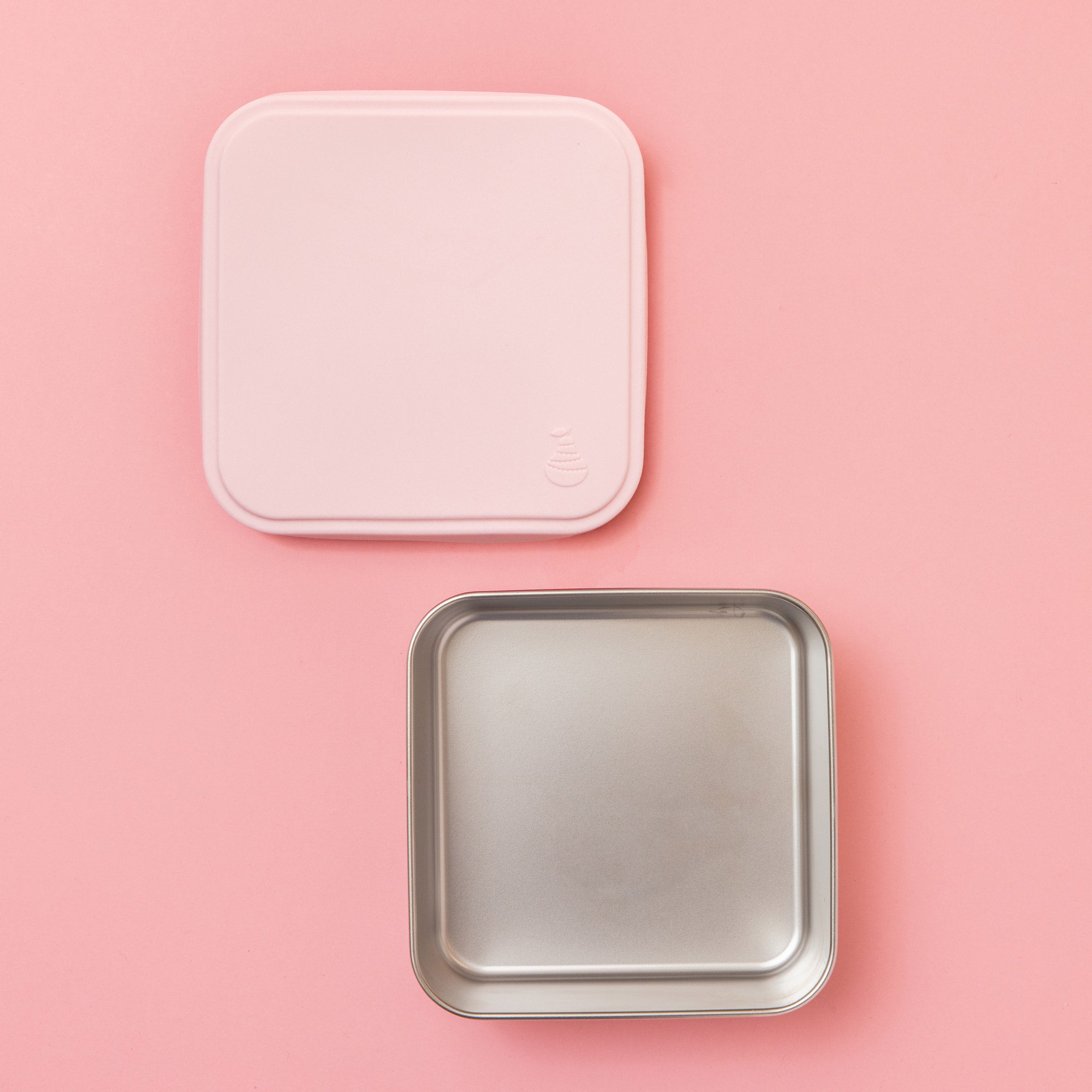 stainless steel square container or sandwich box with pink lid on a pink background empty 