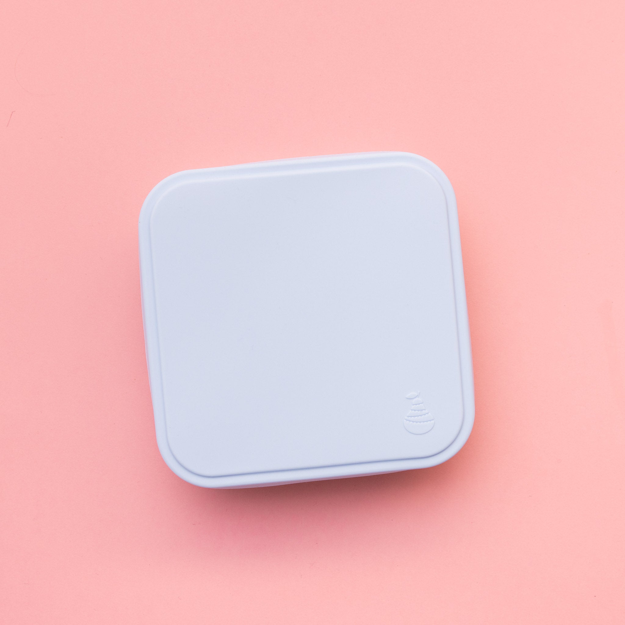 stainless steel square container or sandwich box with blue lid on a pink background empty  showing the lid on pear logo detail 