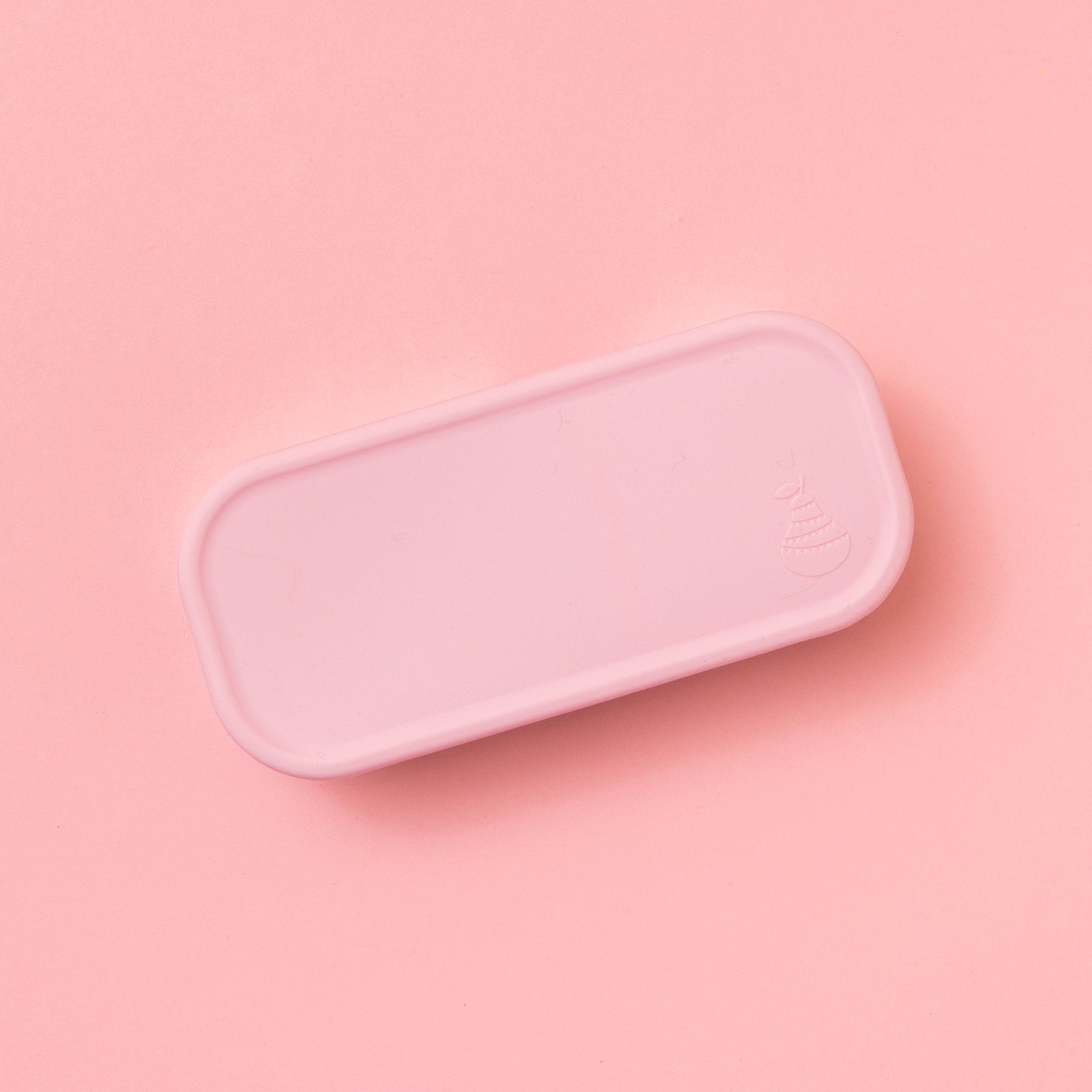 two compartment stainless steel snack container with light pink silicone lid shown from above