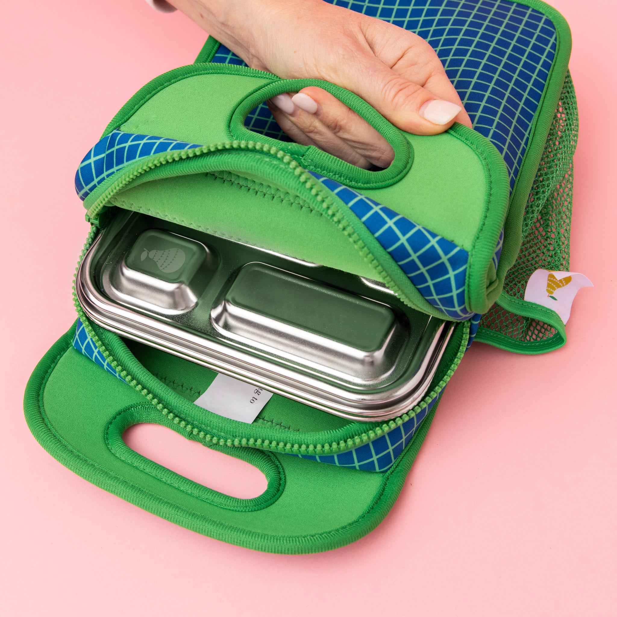 navy neoprene lunch bag with green gridlines and green interior holding out 5 compartment lunch box 