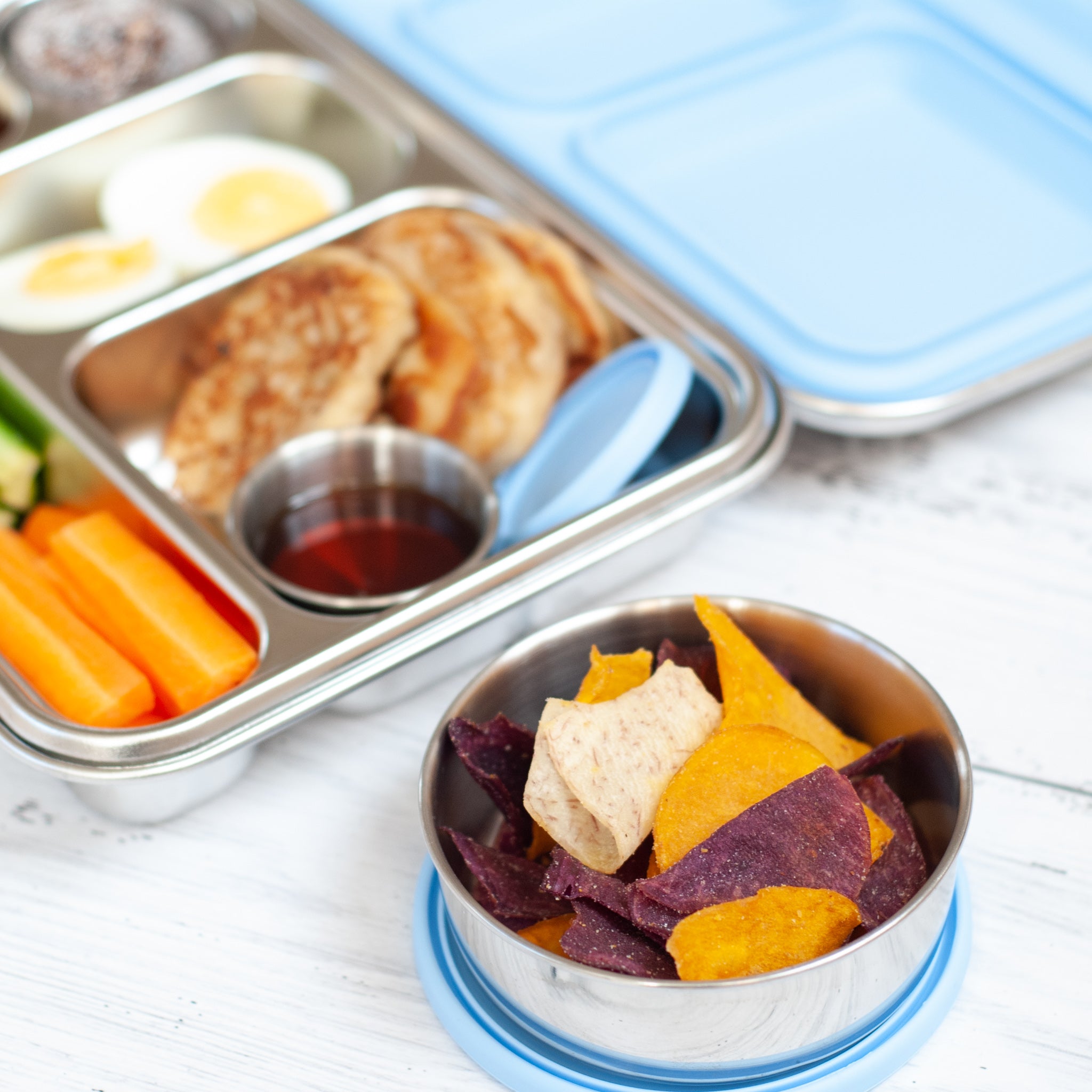 leak proof stainless steel snack container with blue silicone lid. nudie rudie lunch box